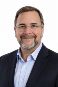 Smiling man in professional attire.